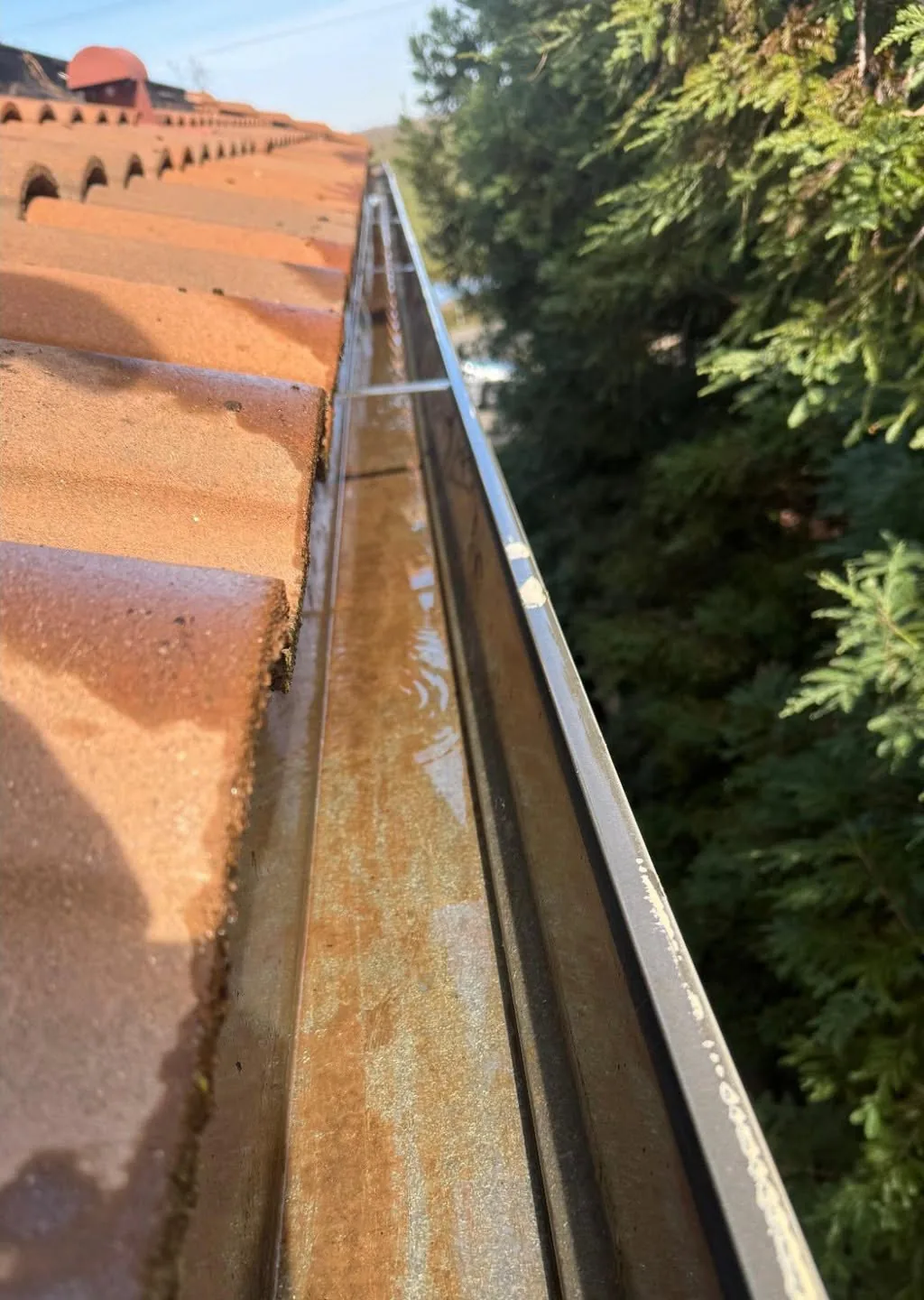 The same gutter running clear after a Dunzo Gutters cleaning