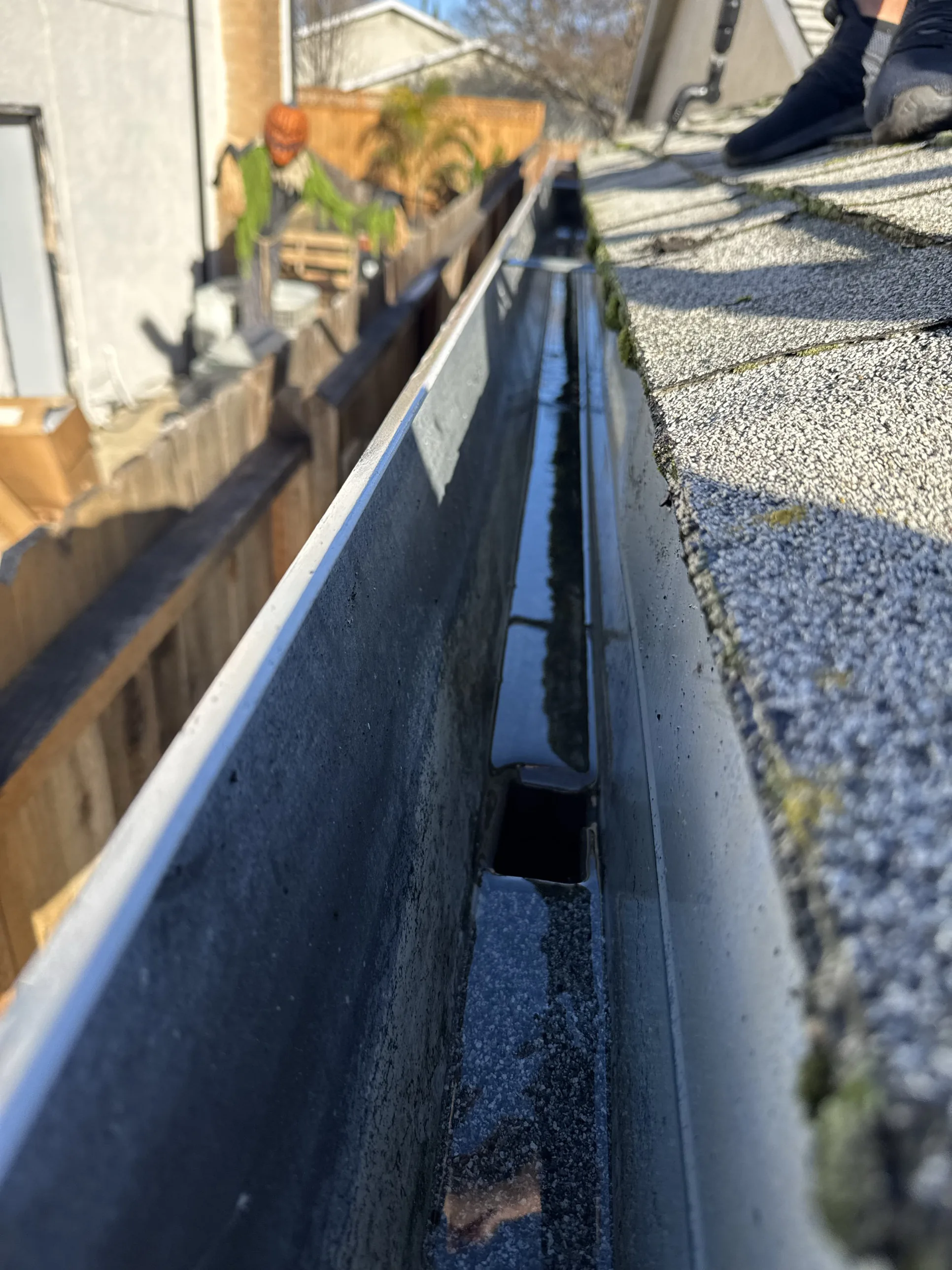 A freshly cleaned gutter channel on a Sacramento home, running clear