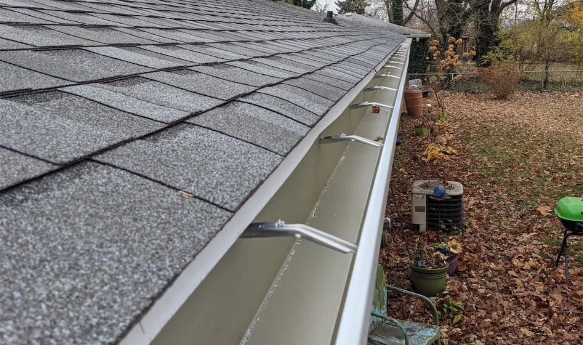 New gutter hangers installed and properly spaced along a Sacramento home's roofline after a repair