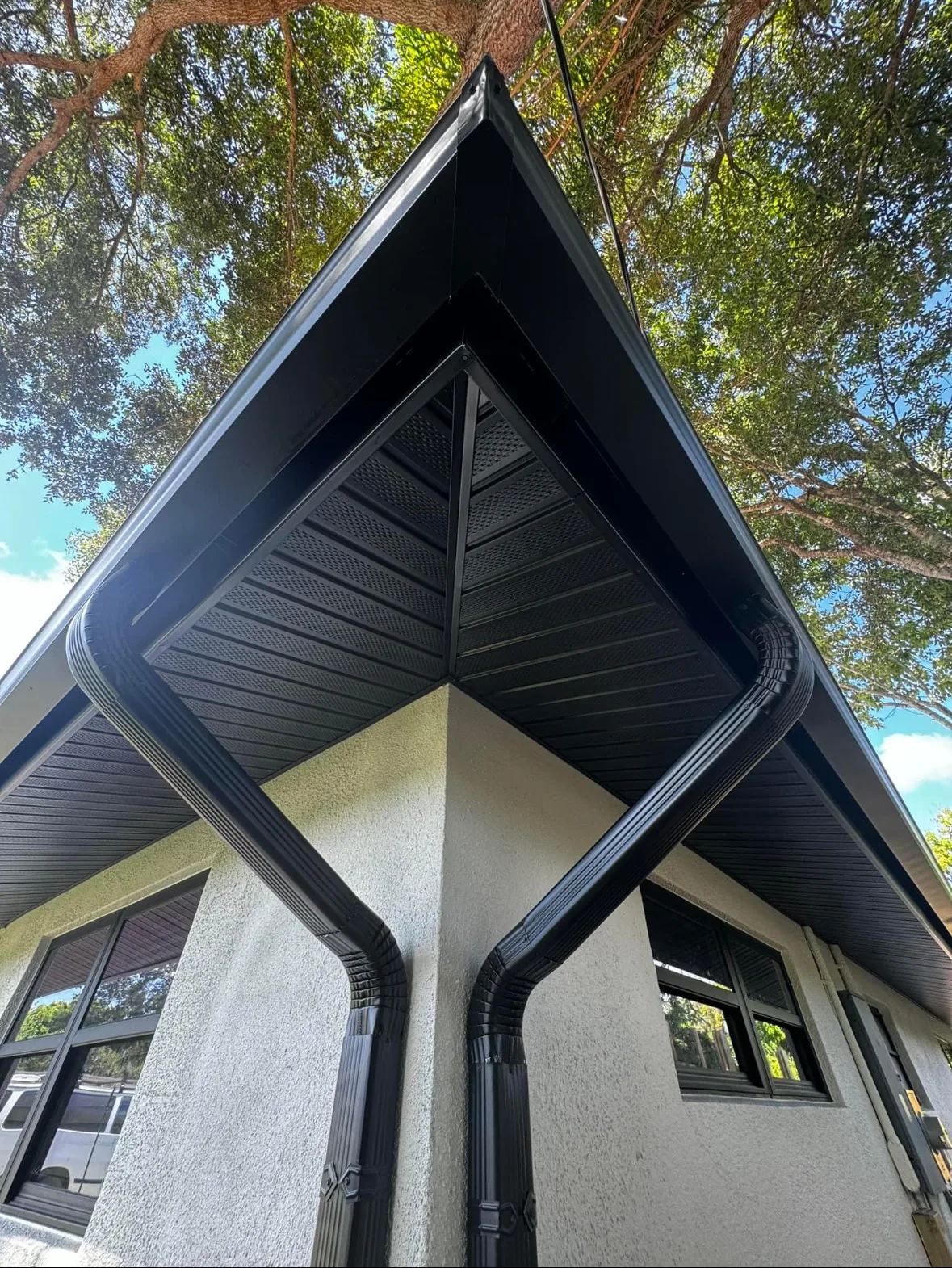 Finished color-matched seamless gutters installed along the roofline corner of a Sacramento home
