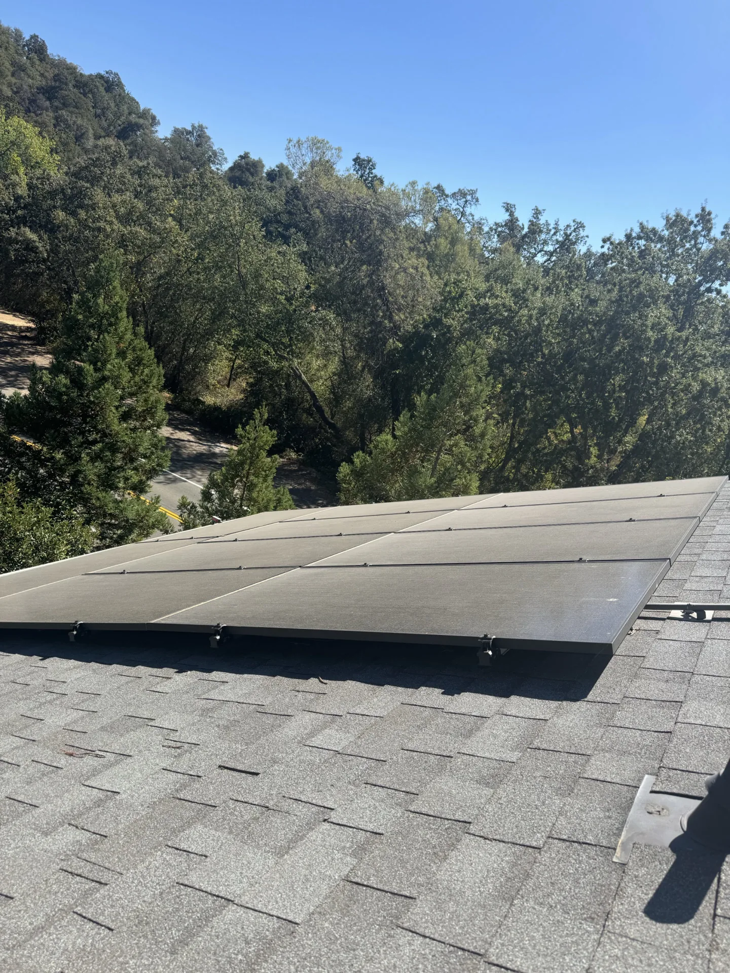 A wide view of dust-covered solar panels on a Sacramento roof