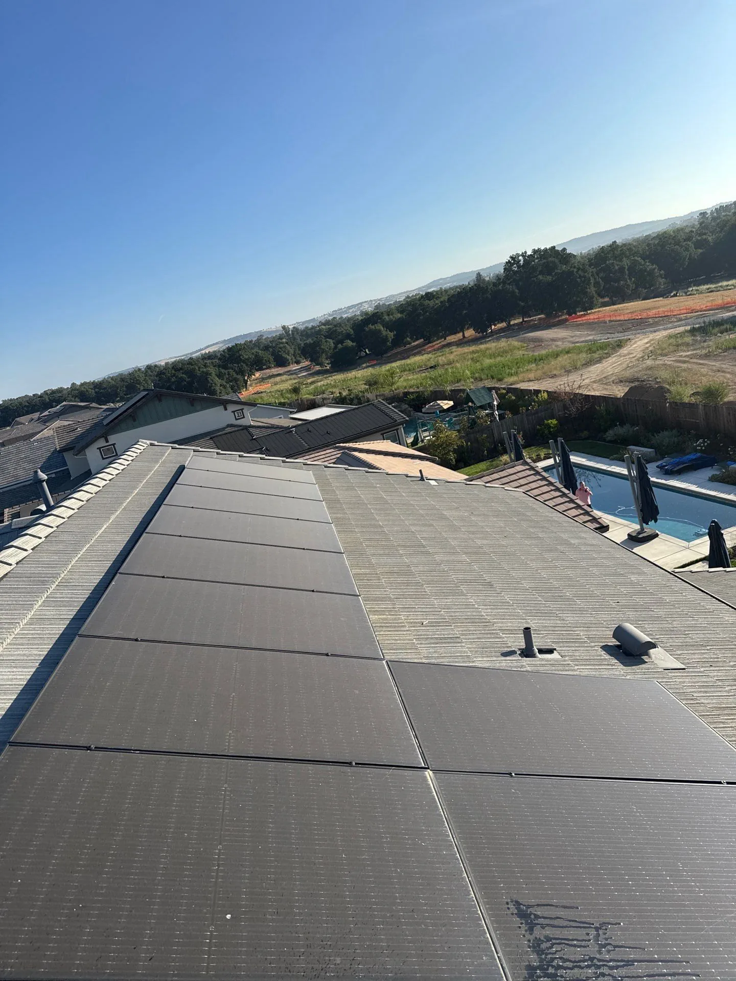 Freshly cleaned solar panels on a Sacramento-area hillside home
