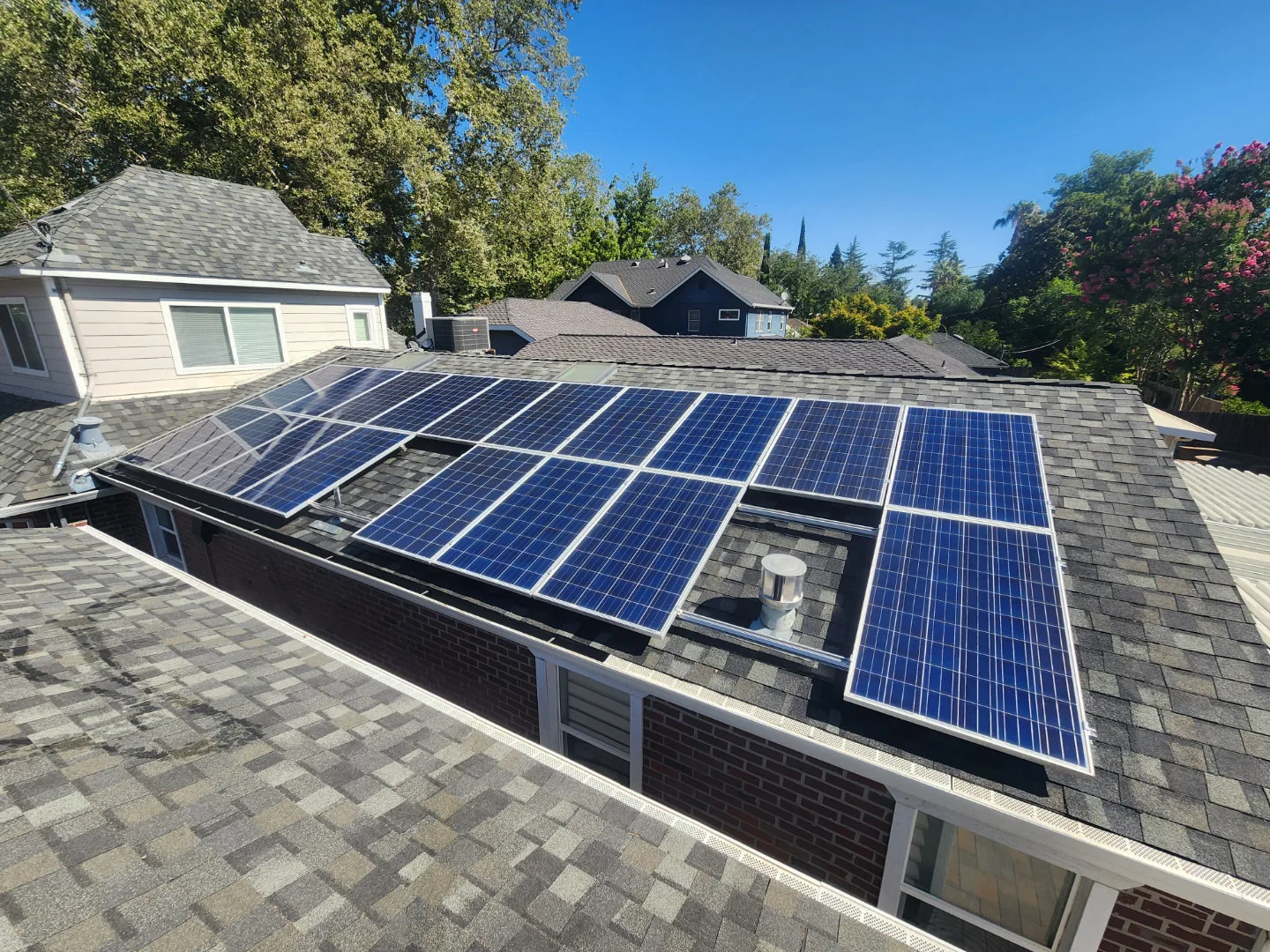 The same solar panels clean and dark after a Dunzo Gutters cleaning