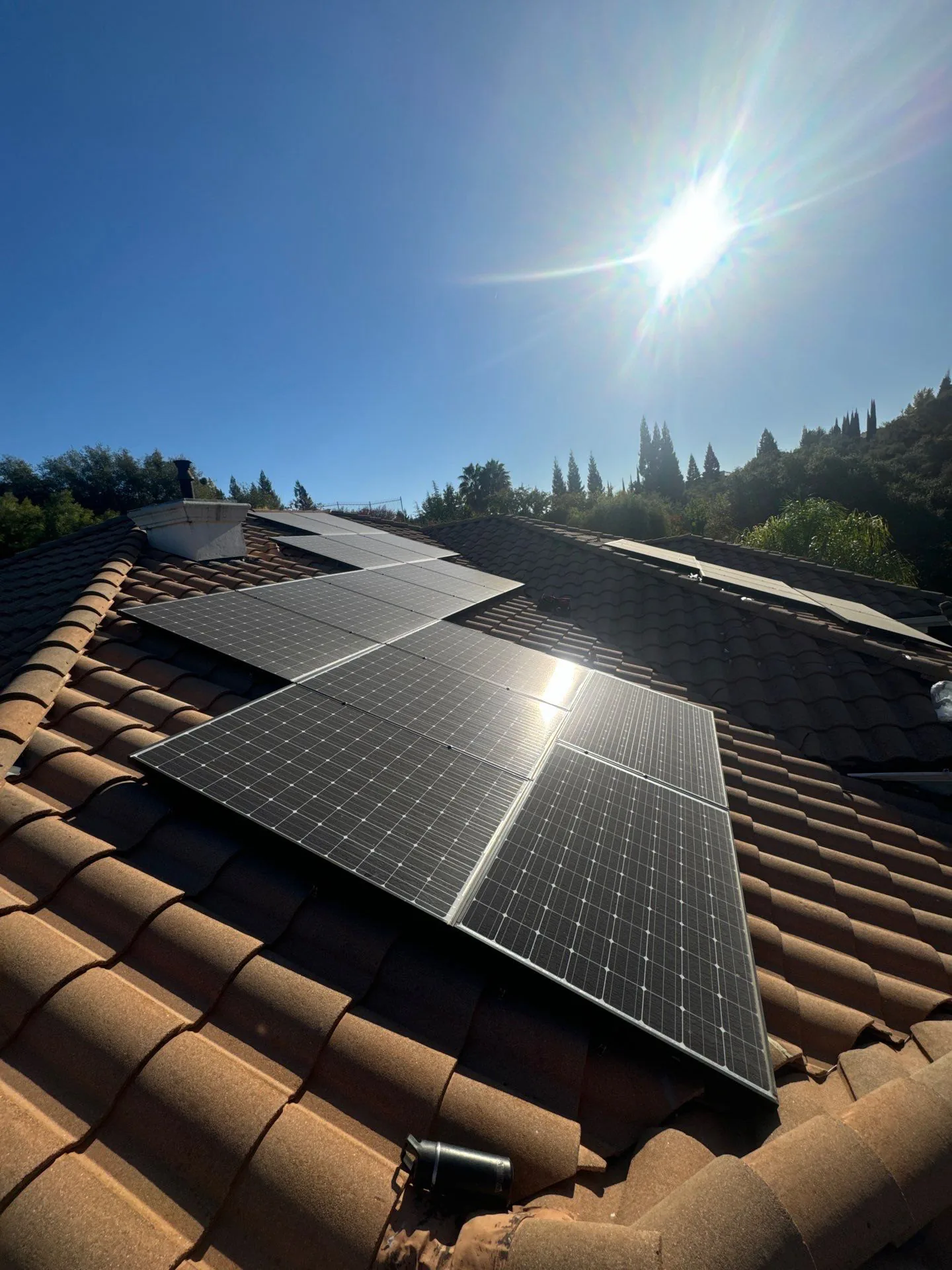 Hazy, dust-covered solar panels on a Sacramento tile roof before cleaning